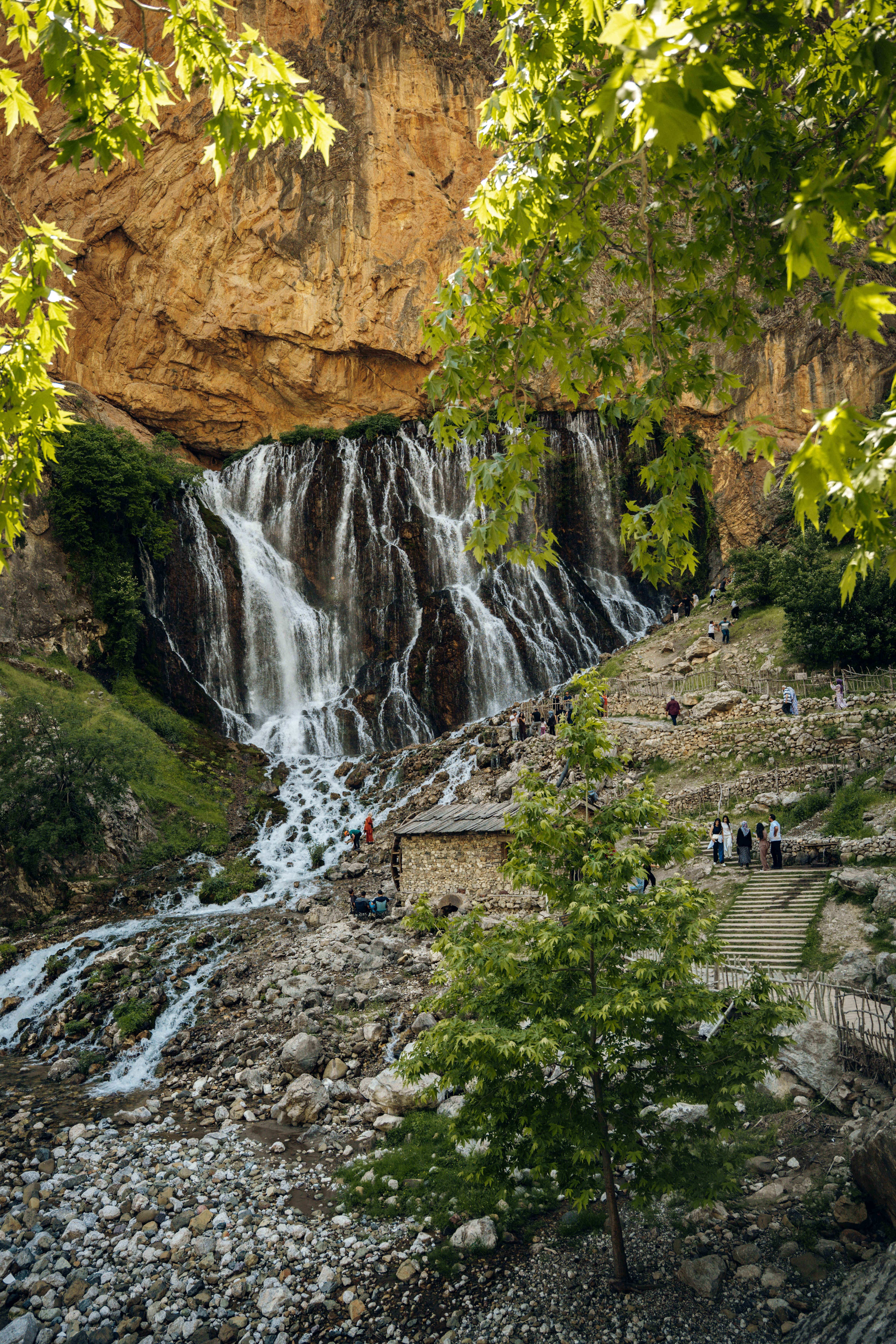 Beautiful Waterfall by Rustic Stone Cabin · Free Stock Photo
