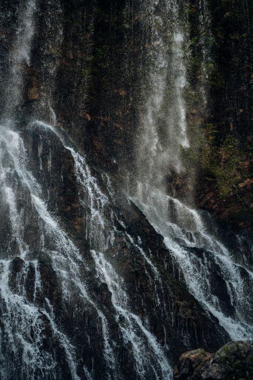 Free Powerful waterfall cascading down rugged rocks creating a mesmerizing natural spectacle. Stock Photo