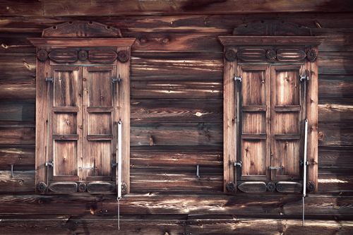 Free Close-up of vintage wooden shuttered windows on a rustic log cabin wall. Stock Photo