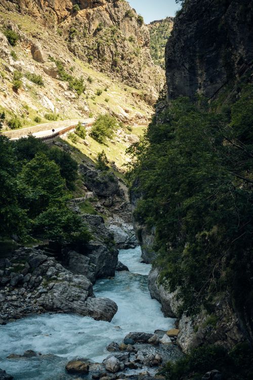 Free Breathtaking view of a clear river flowing through a rocky mountain valley. Stock Photo