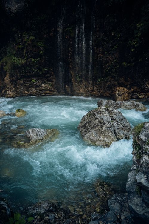 Free Serene mountain stream flowing with crystal-clear water and gentle waterfall. Stock Photo