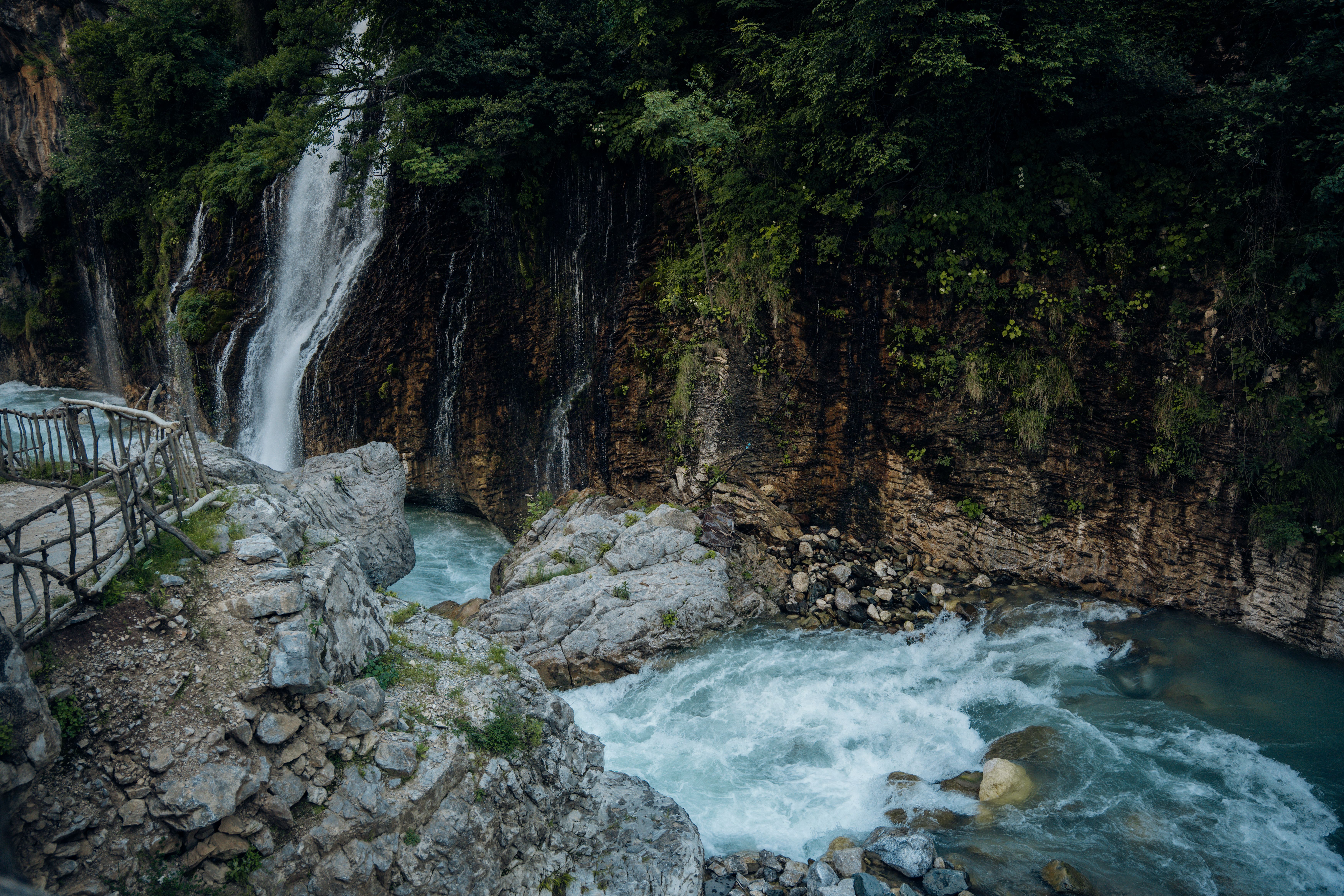 Scenic Waterfall Flowing Into Rocky Stream · Free Stock Photo