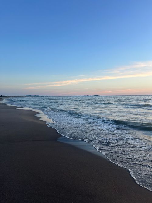 Free Tranquil evening scene capturing the serene waves and sunset at Durrës Beach, Albania. Stock Photo
