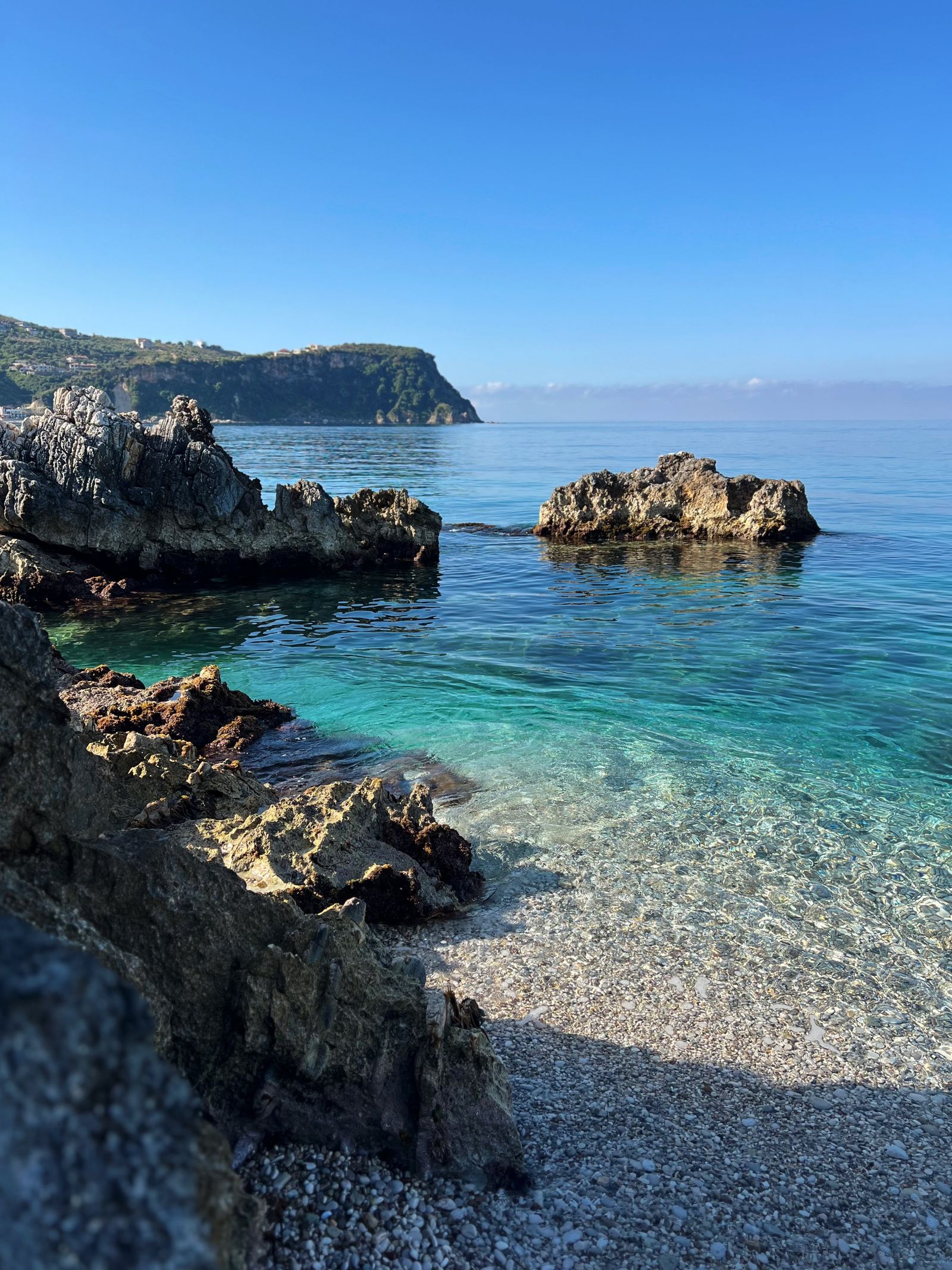 Rocky beach and clear Ionian water near Himarë on the Albanian Riviera