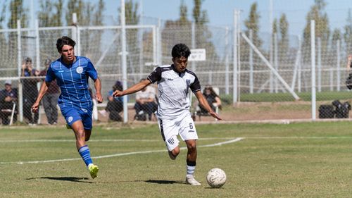 Free Two young men competing fiercely during a soccer match on a sunny day outdoors. Stock Photo