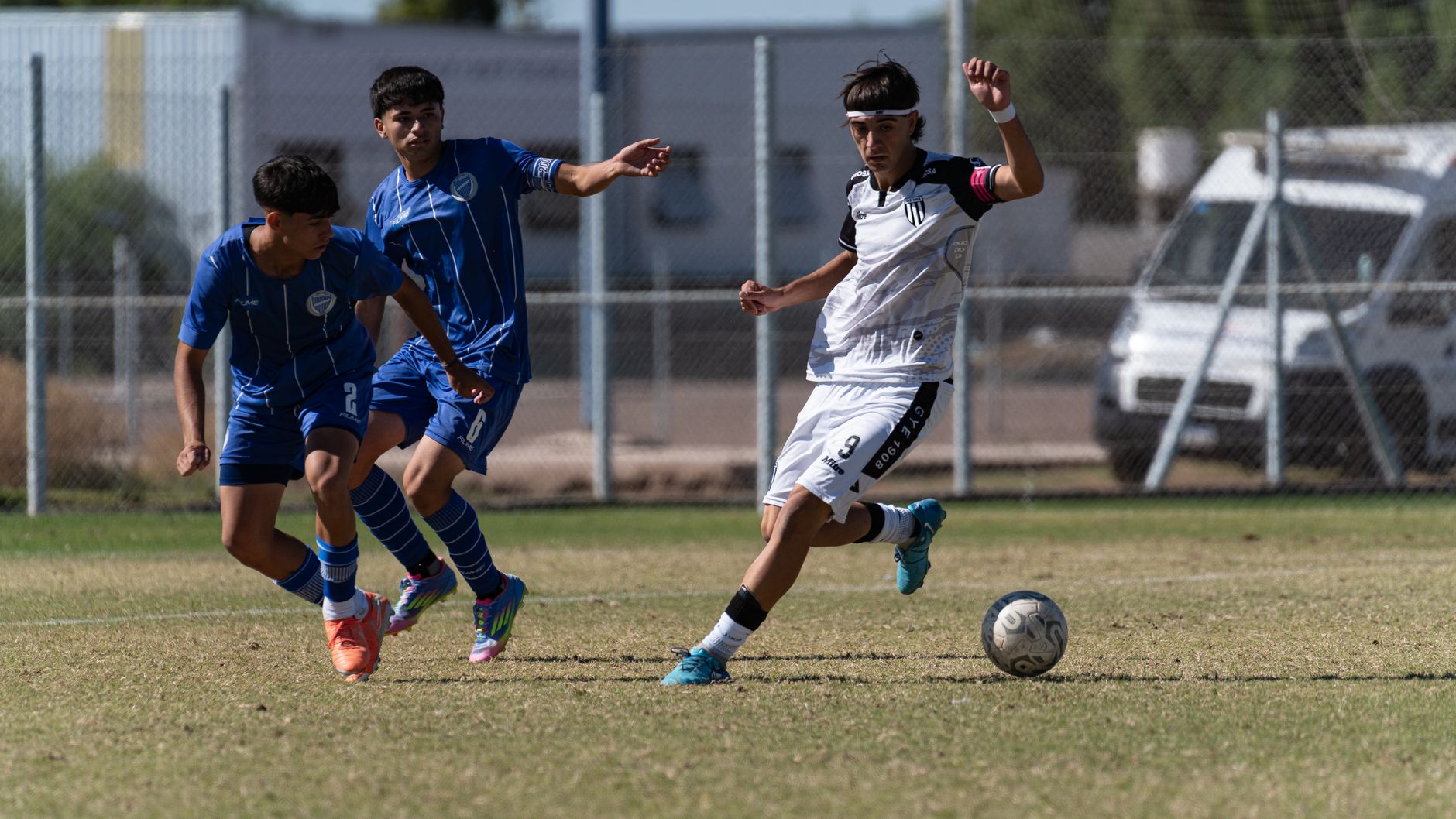 Intense moment in a youth soccer match with players in action.