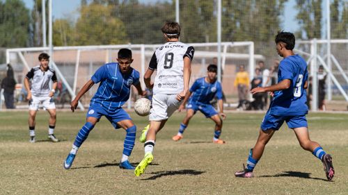 Free Dynamic scene of teenage soccer players competing on a sunny day. Stock Photo