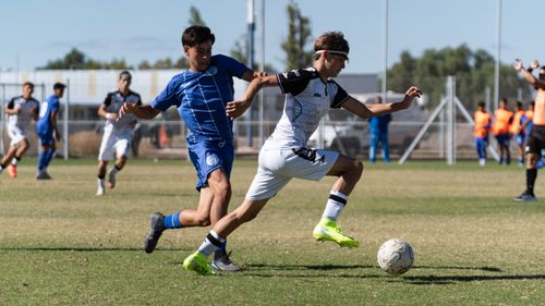 Free Two soccer players in action during an outdoor match, showcasing skill and speed. Stock Photo