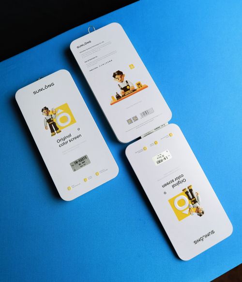 Free Three Sunlong product packages arranged on a vibrant blue surface, showcasing design and branding. Stock Photo