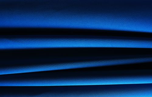 Free Captivating close-up of blue fabric folds with abstract patterns and lighting effects. Stock Photo