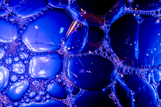 Dynamic close-up of vivid blue bubble textures creating an abstract and futuristic pattern.