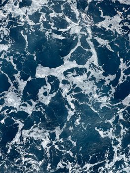Aerial photograph capturing the dynamic and frothy ocean waves in Malta.