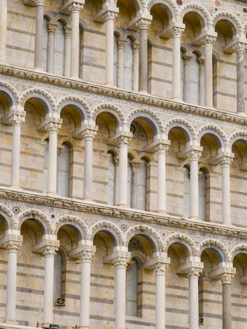Free Detailed view of the ornate arches on the facade of Pisa Cathedral in Italy. Stock Photo