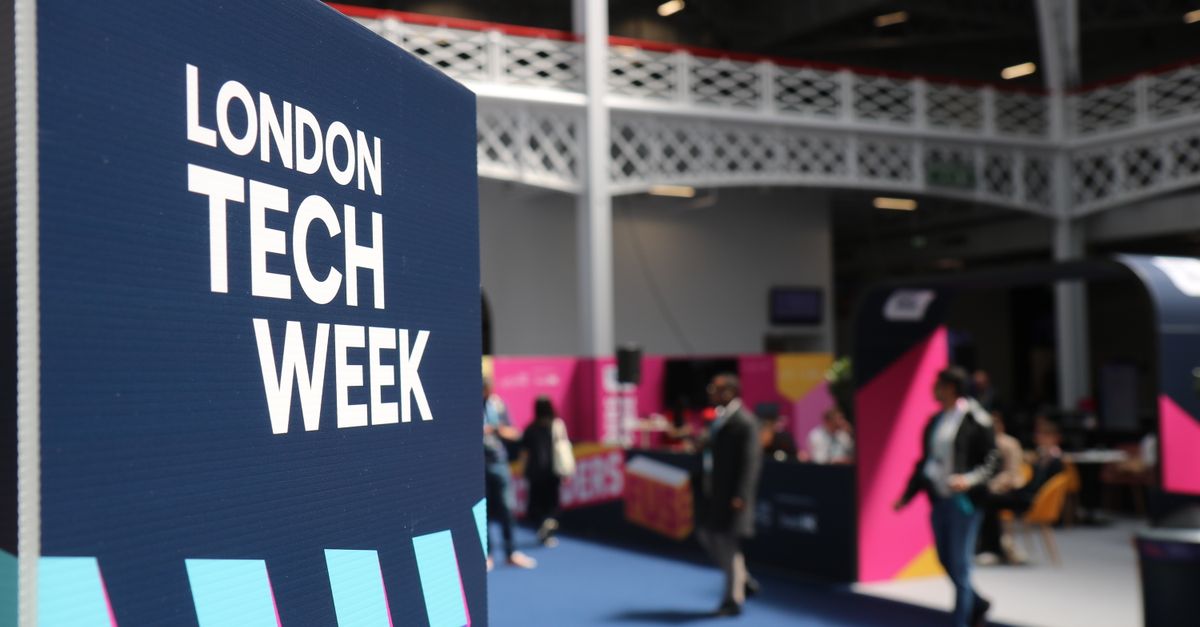 Vibrant indoor scene at London Tech Week with attendees and colorful displays.