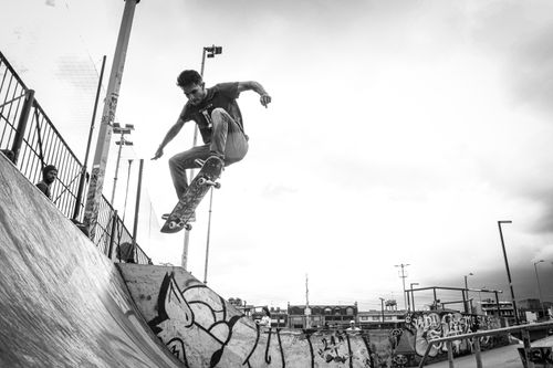 Free Skateboarder executing a trick in Bogotá skate park, highlighting urban street culture. Stock Photo
