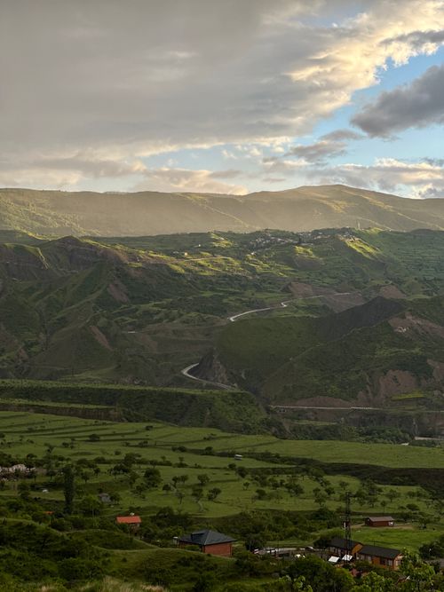 Free Stunning view of lush green mountains and valleys during sunset, creating a serene and picturesque scene. Stock Photo