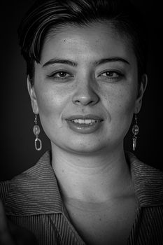 Elegant black and white portrait photo capturing a woman's smile with striking details.
