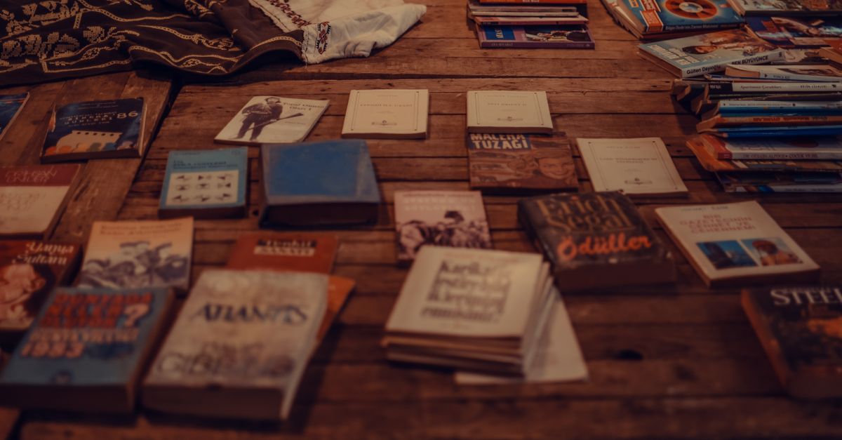 Paperback books stacked on a table for a book giveaway