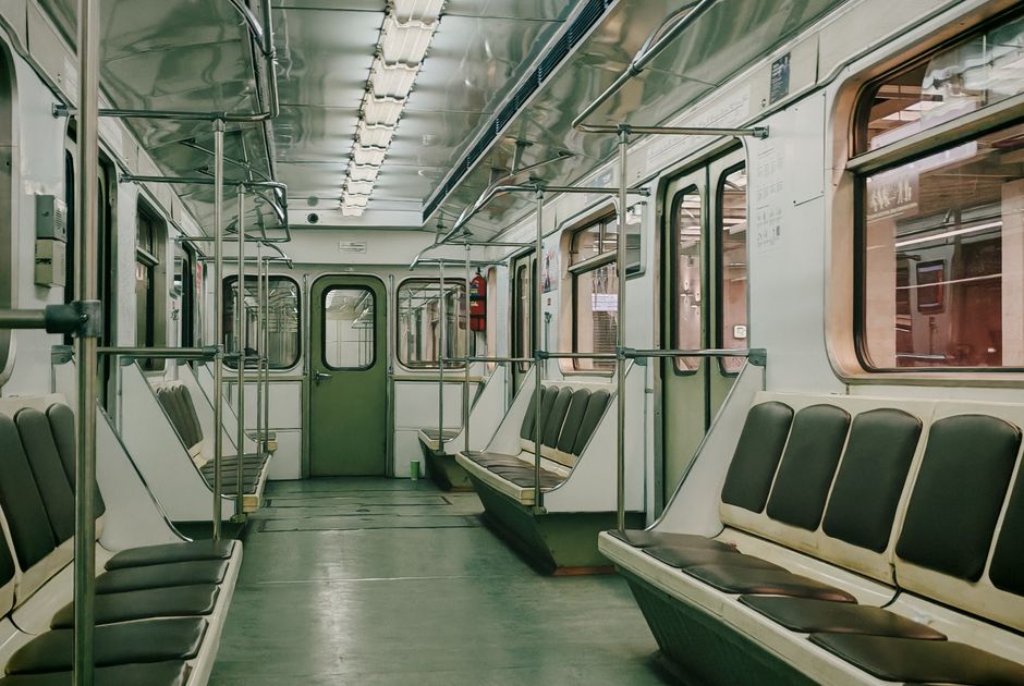 Interior of a Yerevan Metro train in Armenia, showing local commuters.