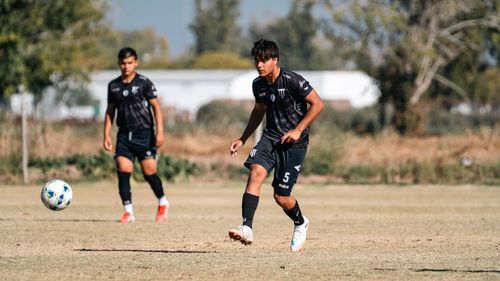 Free Dynamic shot of young soccer players on a field during a sunny day. Stock Photo