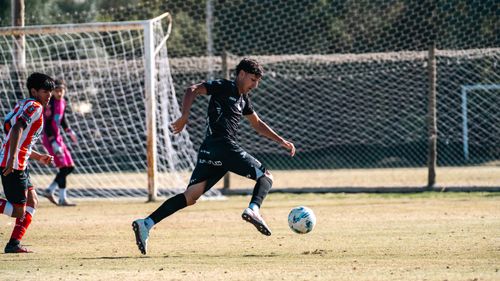 Free Dynamic scene of a youth soccer match with players in action on a sunny day. Stock Photo