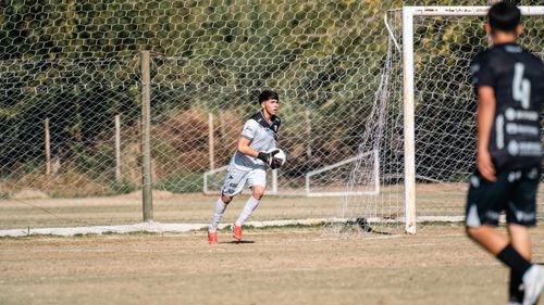 Free A soccer goalie in mid-action on a sunny day during a local match. Stock Photo