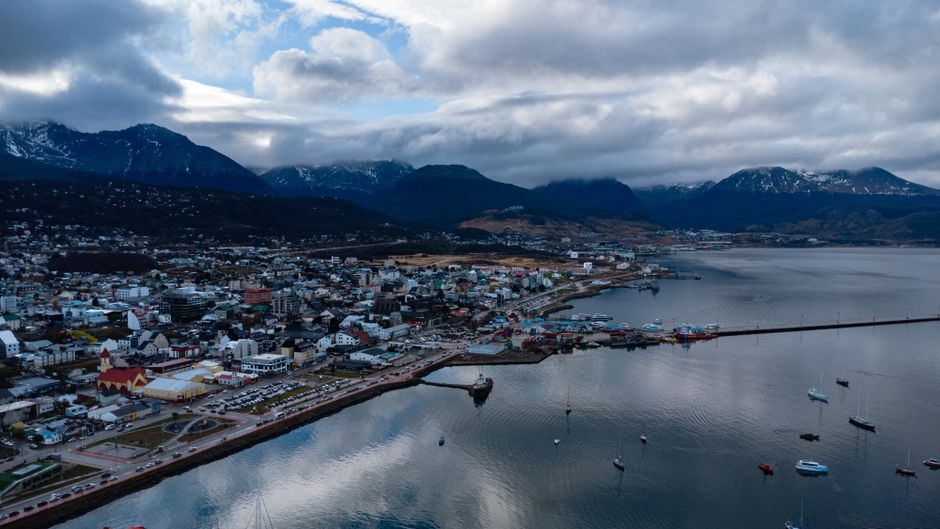 Incredible Private Tour Iguaçu Waterfalls + Helicopter Flight Review 2026 - Aerial view of Ushuaia, the southernmost city in Argentina, with mountains and harbor in view.