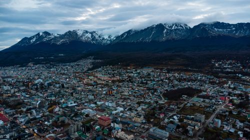 Free A stunning aerial view of Ushuaia, Argentina, with snow-capped mountains and a bustling cityscape. Stock Photo