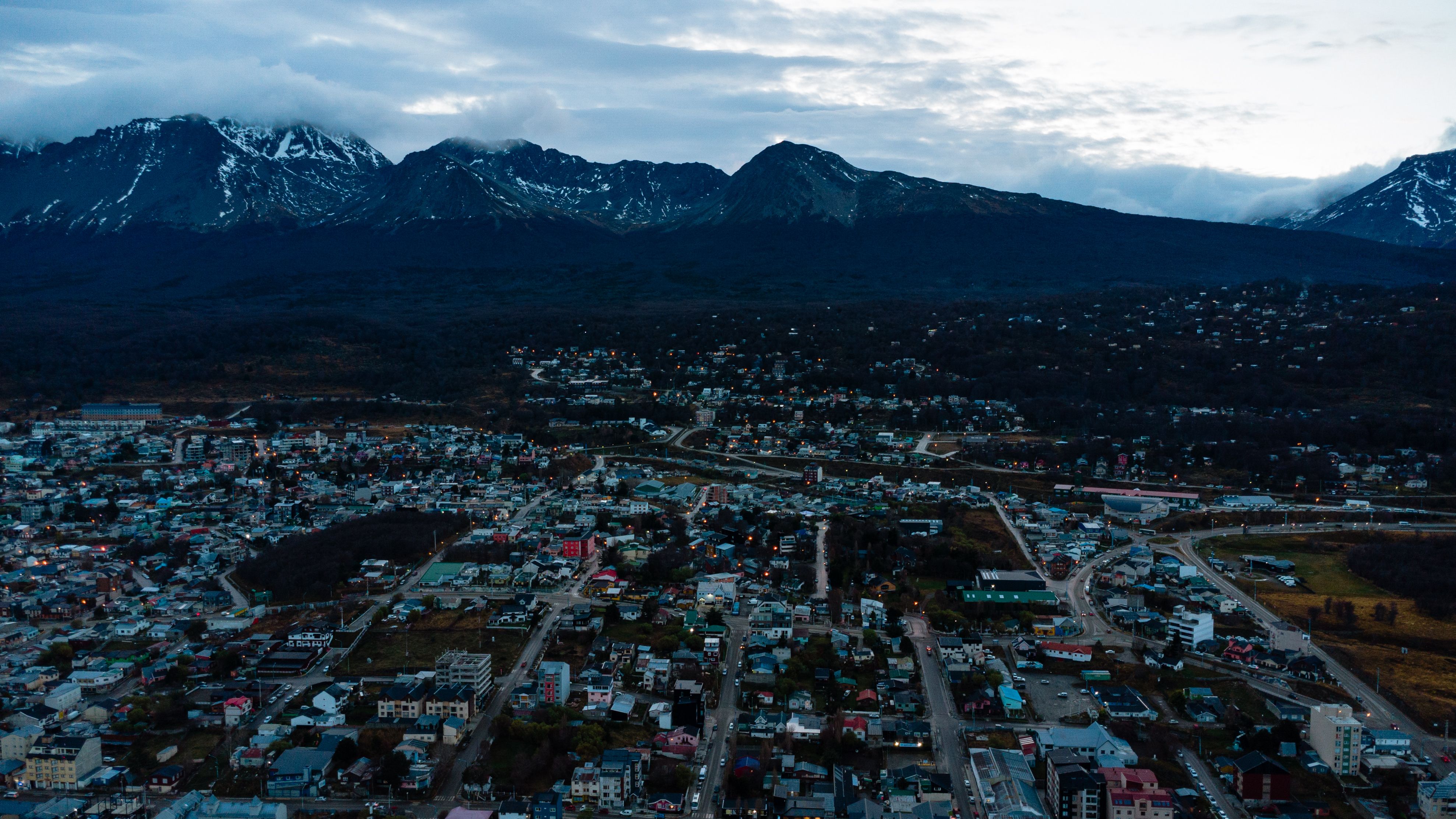Grand Knik Helicopter Tour - 2 hours 3 landings - ANCHORAGE AREA - A stunning aerial view of Ushuaia, Argentina with snow-capped mountains in the backdrop during twilight.