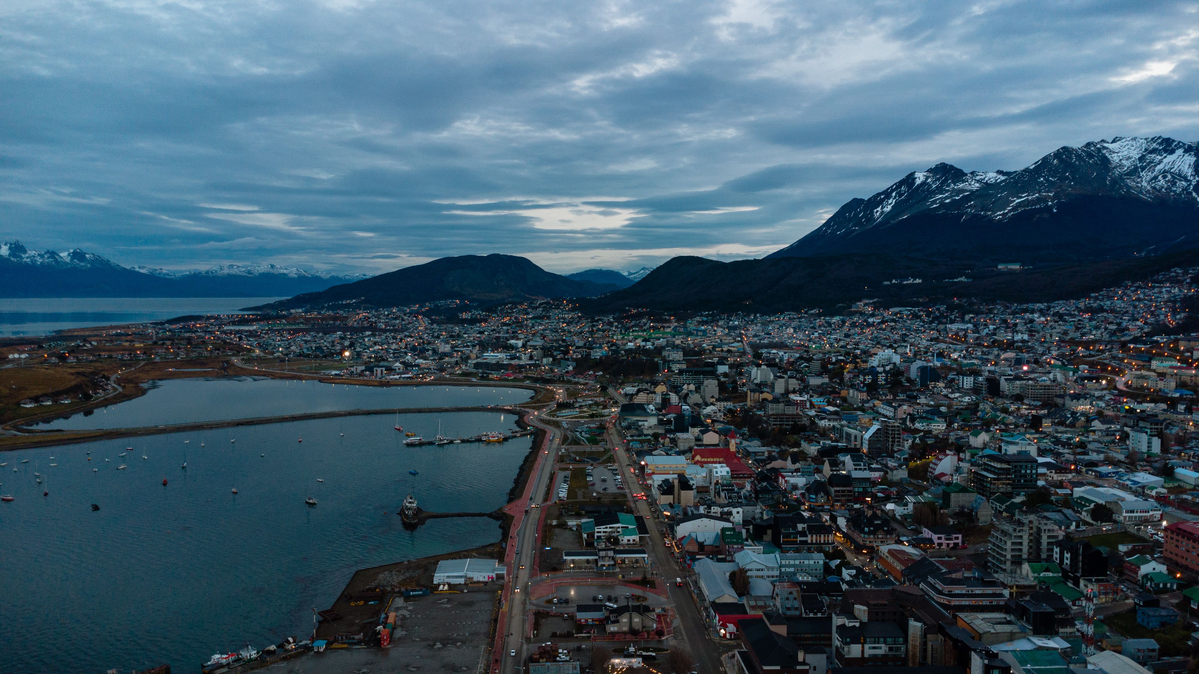 Incredible Private Tour Iguaçu Waterfalls + Helicopter Flight Review 2026 - A picturesque aerial view of Ushuaia City bordered by the Andes Mountains and coastal waters.