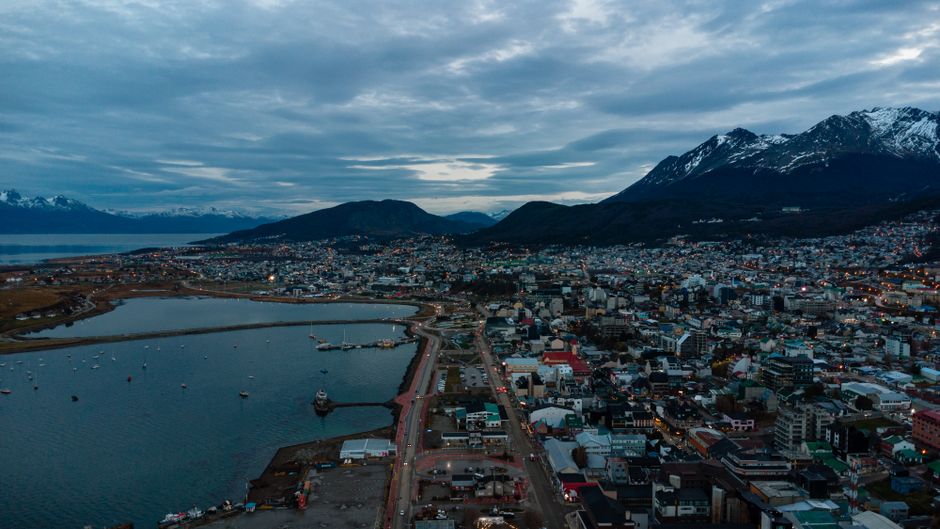 Incredible Private Tour Iguaçu Waterfalls + Helicopter Flight Review 2026 - A picturesque aerial view of Ushuaia City bordered by the Andes Mountains and coastal waters.
