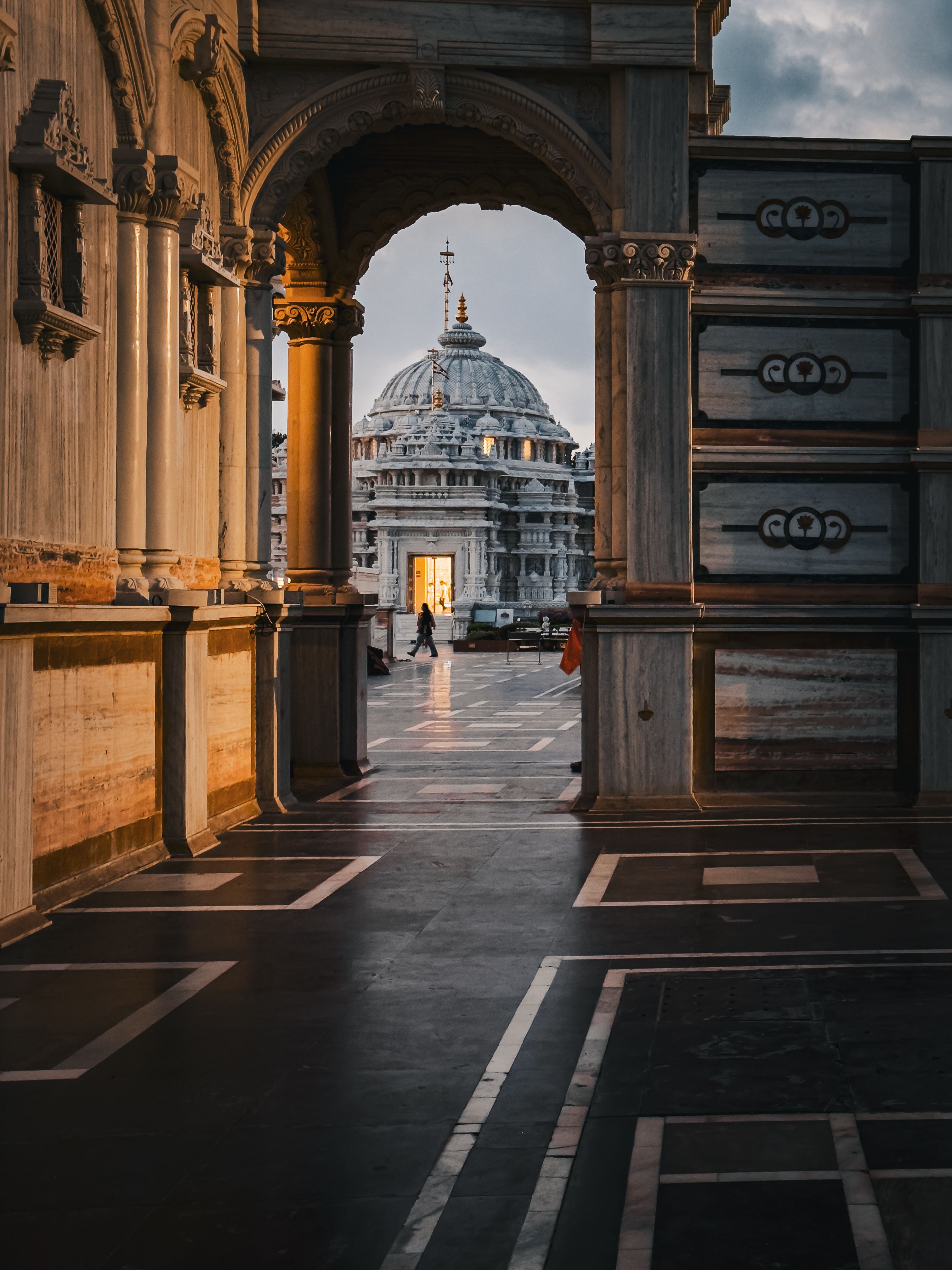 Dramatic sunset view through archway revealing iconic Italian domed architecture.