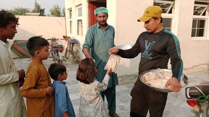 Volunteers sharing food with children in a local community