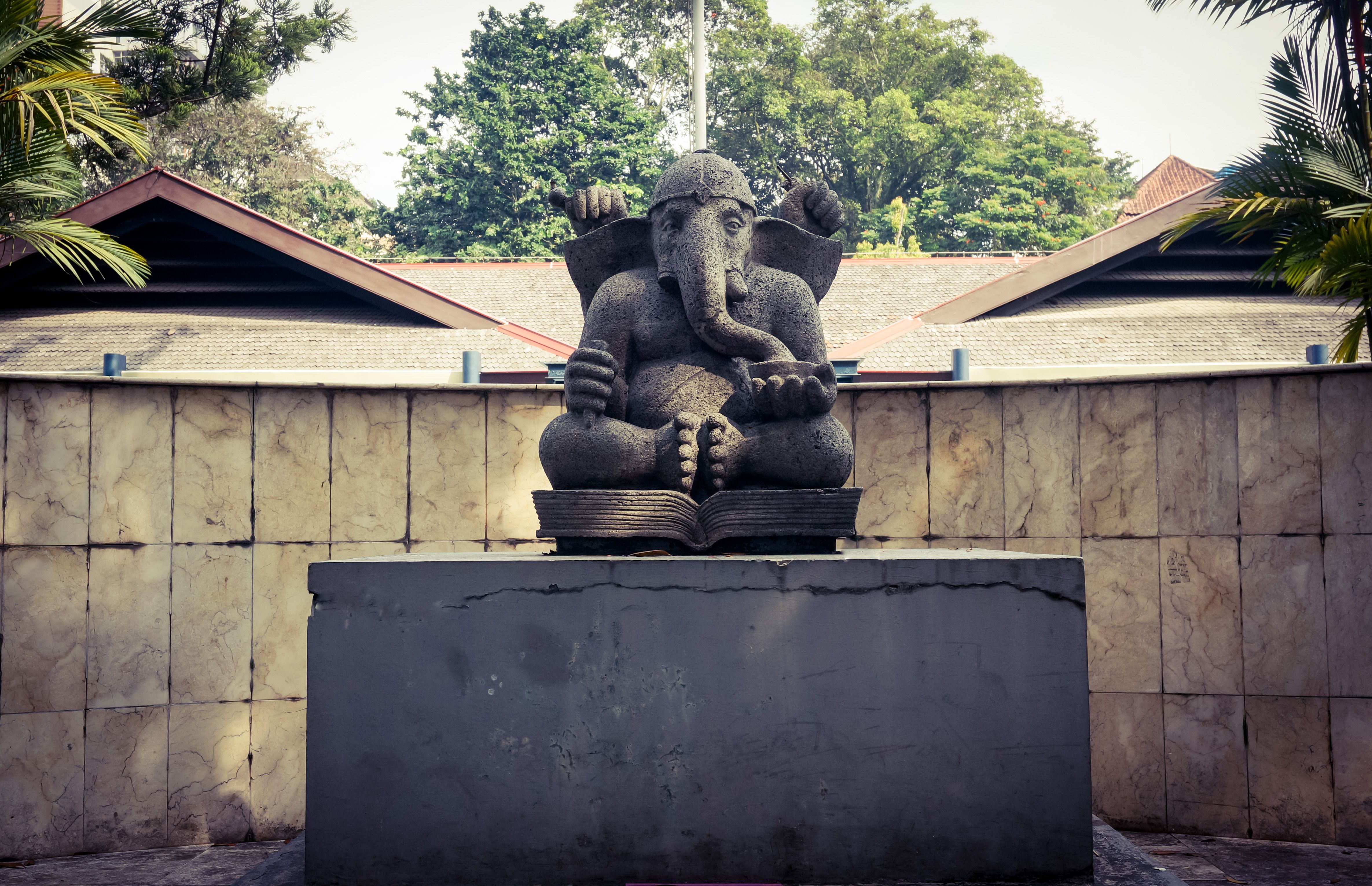 A serene Ganesha statue in an outdoor setting in Bandung, Indonesia.