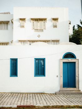 Elegant Mediterranean architecture with classic white walls and vibrant blue accents creating a serene vibe.
