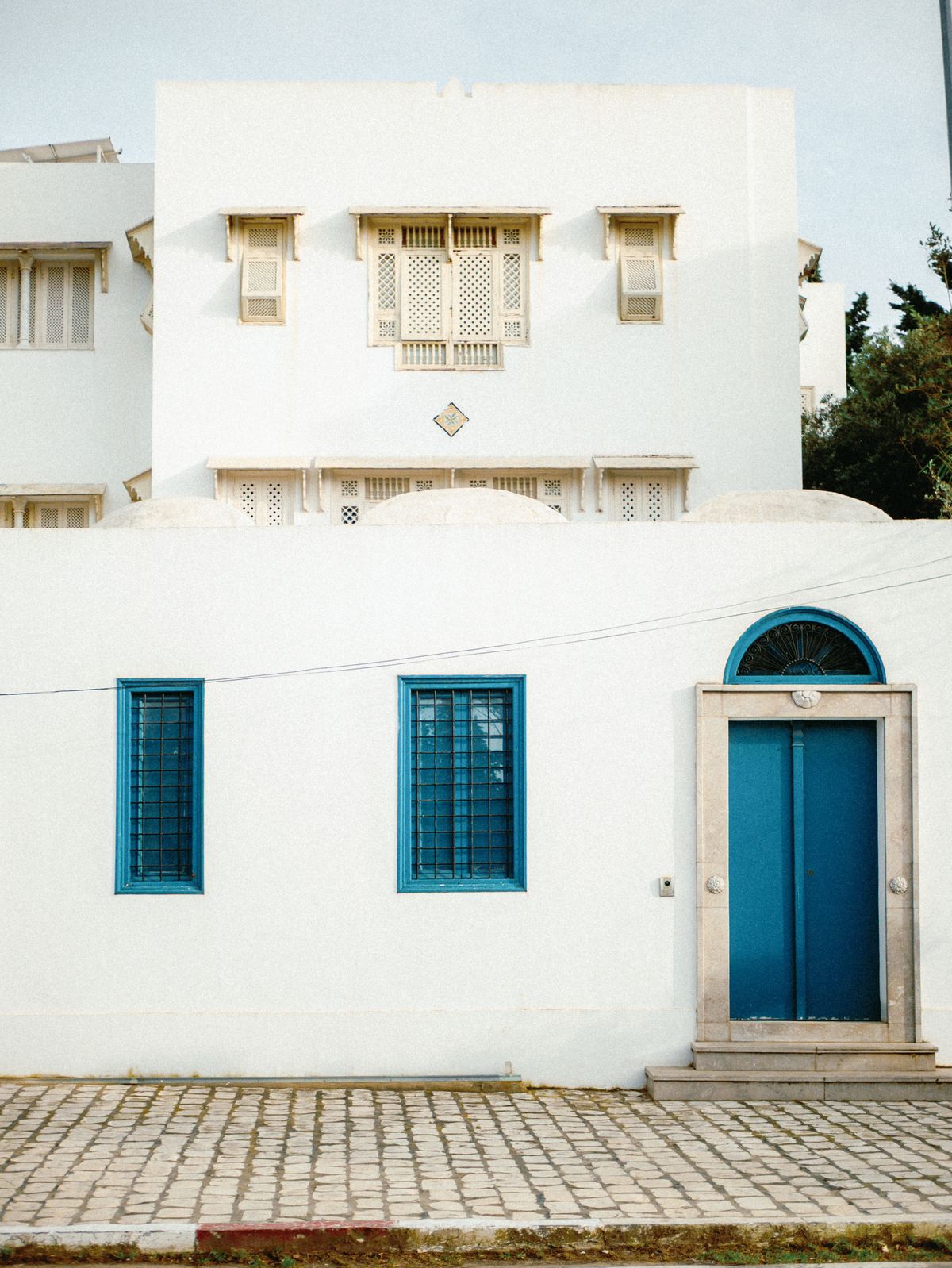 White and blue Mediterranean house exterior in a traditional setting