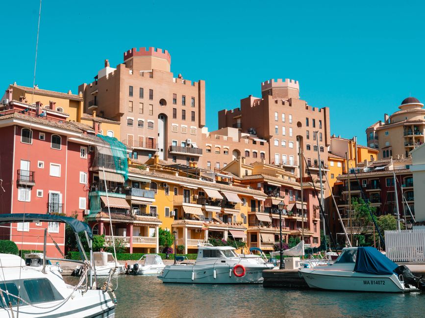 Vibrant architectural scene with boats at Port Saplaya Marina, Valencia, Spain.