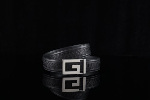 Free Elegant black leather belt with unique buckle design against a dark background. Stock Photo