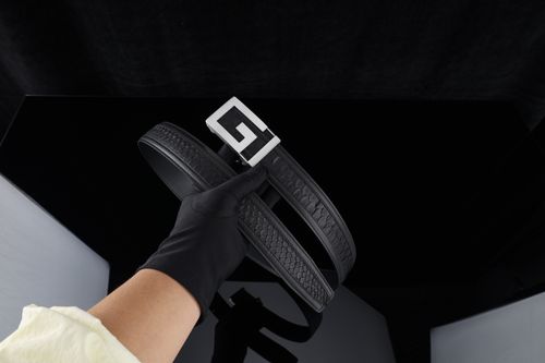 Free Elegant black leather belt with a bold geometric buckle, perfect for fashion enthusiasts. Stock Photo