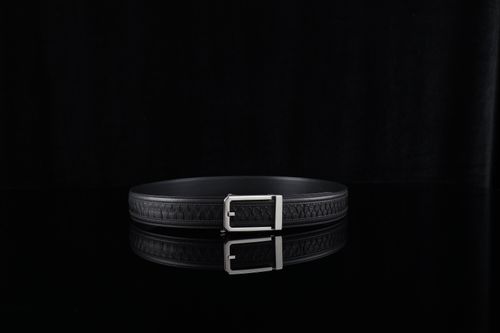 Free A minimalist photo of a refined black leather belt with a silver buckle, perfect for fashion and accessory themes. Stock Photo