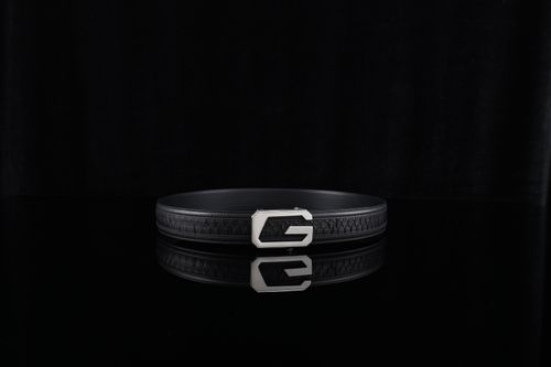 Free Luxurious black leather belt with a sleek metal buckle reflecting against a dark surface. Stock Photo