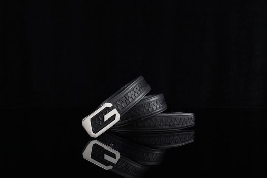 Sleek black leather belt with a modern buckle, perfect for fashion-forward ensembles.