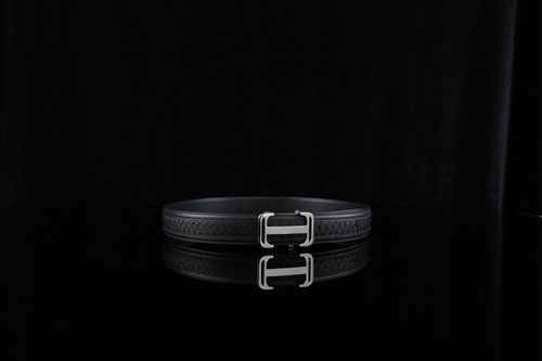 Free Elegant black leather belt with a metallic buckle on a glossy surface, perfect for fashion styling. Stock Photo