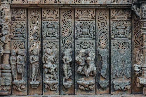Free Intricate stone carvings depicting human figures on a historic temple in Udaipur, India. Stock Photo