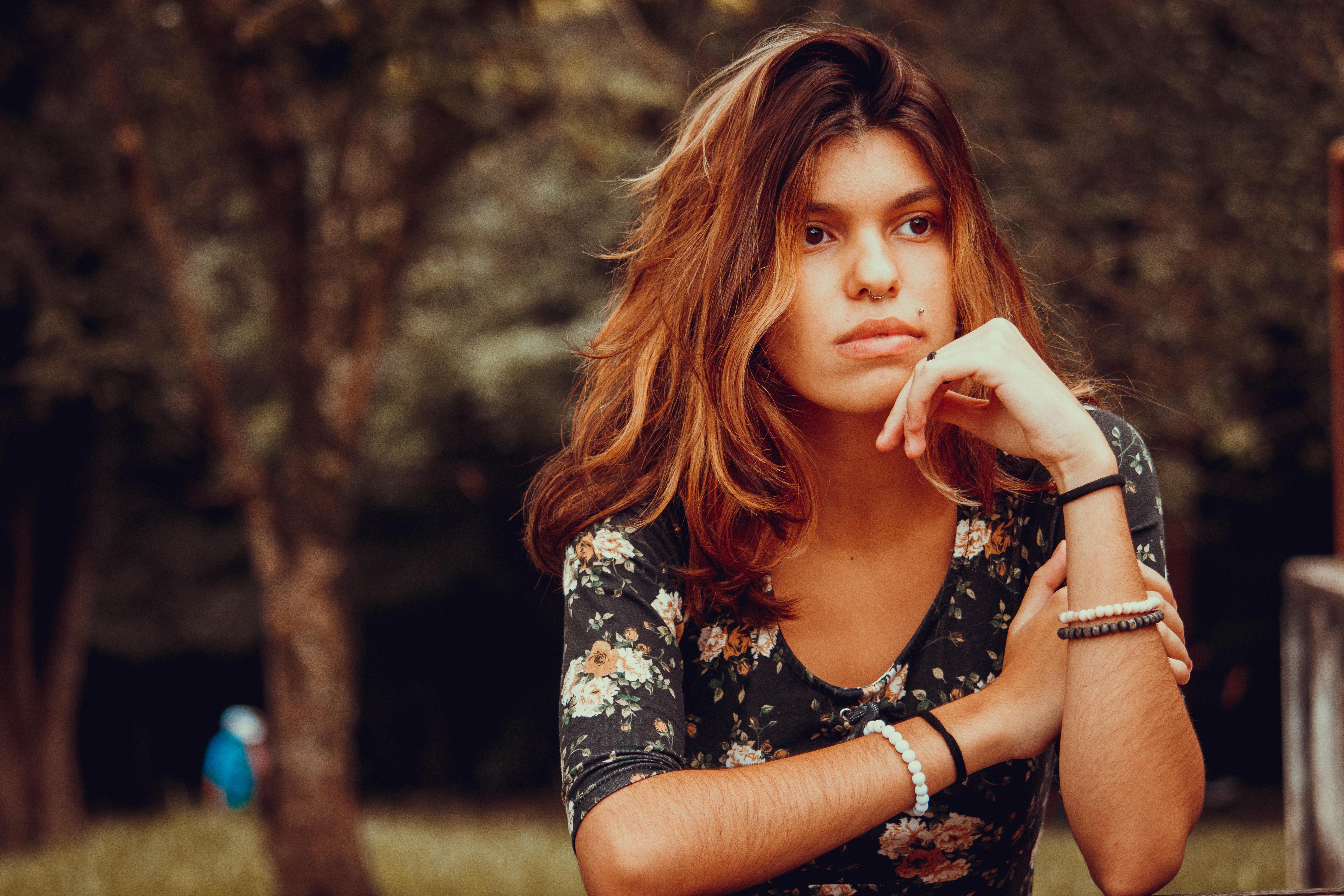 pensive young woman dreaming in garden