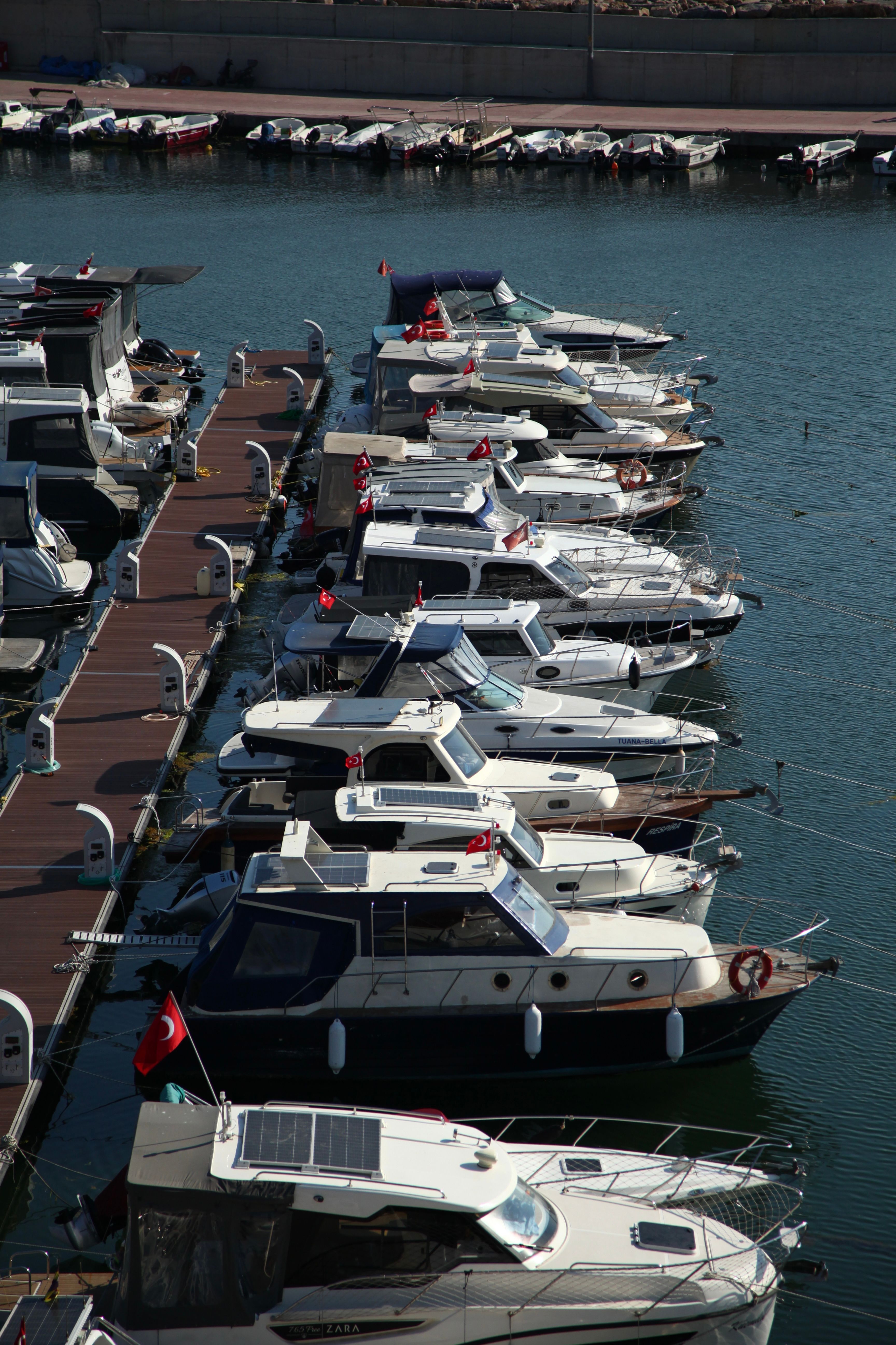 An array of luxury boats docked in a marina, offering a serene view.