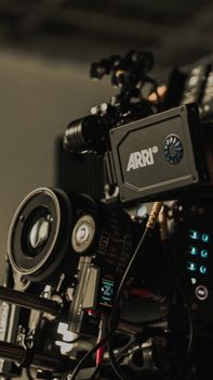Detailed view of high-end cinematography camera gear, focusing on the lens and ARRI box.