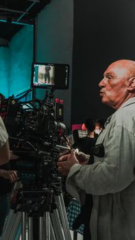 Veteran cinematographer managing camera setup during a studio film production in İstanbul.
