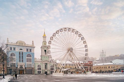 Free Captivating winter cityscape of the Podil Ferris Wheel and historic architecture in Kyiv, Ukraine. Stock Photo