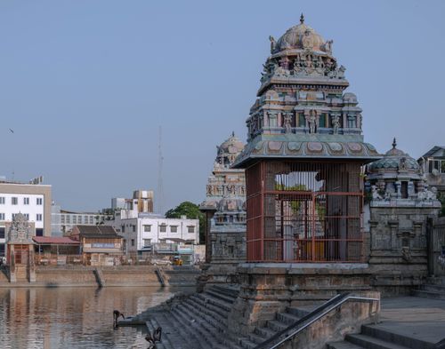 Free Beautiful temple structures reflected by a serene water body in Kumbakonam, India. Stock Photo